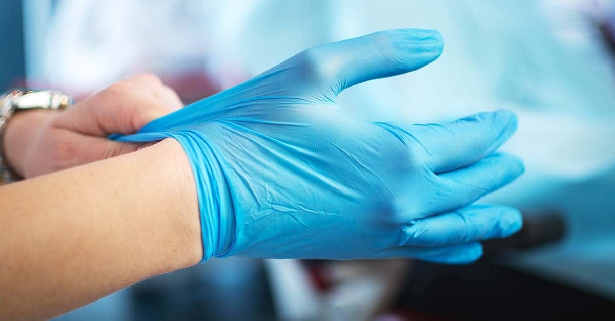 putting on medical gloves